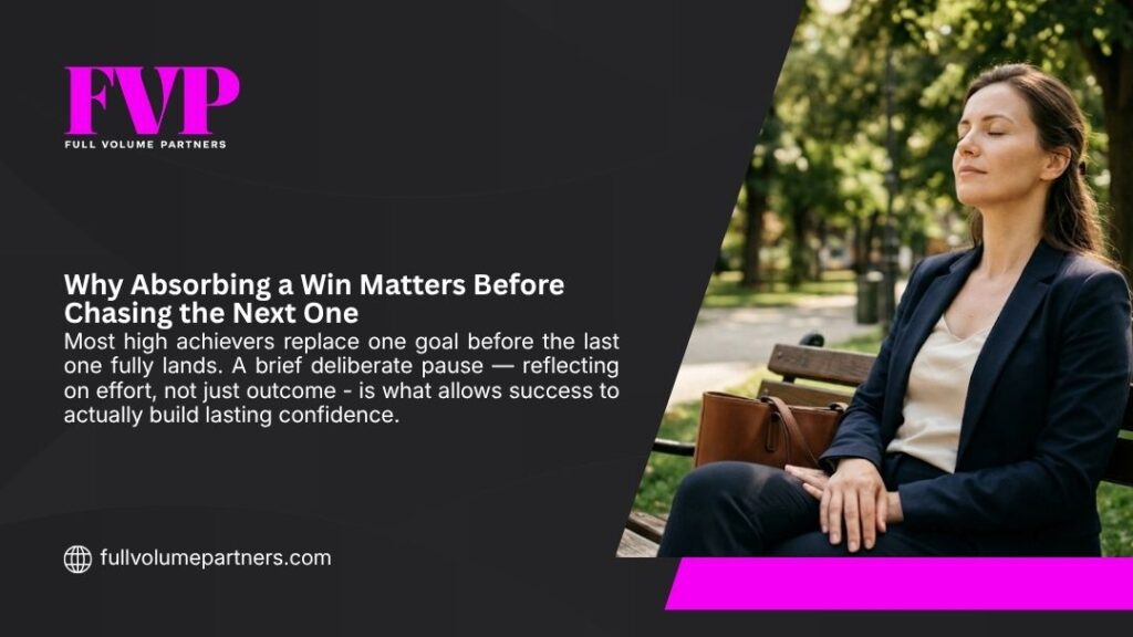 Businesswoman pausing mindfully on a park bench with eyes closed, absorbing a win before chasing the next goal to build lasting confidence.